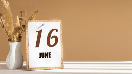 june 16. 16th day of month, calendar date.White vase with dead wood next to cork board with numbers. White-beige background with striped shadow. Concept of day of year, time planner, summer month