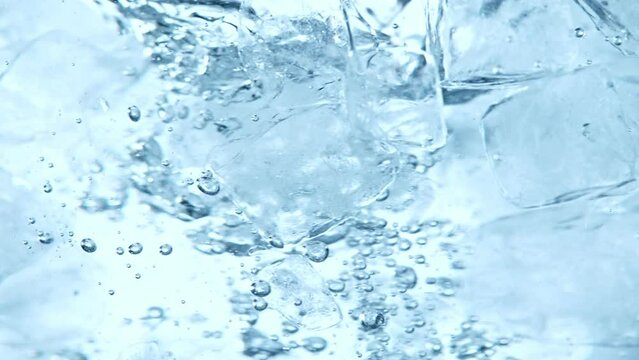 Super slow motion of rotating ice cubes in water. Filmed on high speed cinema camera, 1000 fps. Underwater composition.