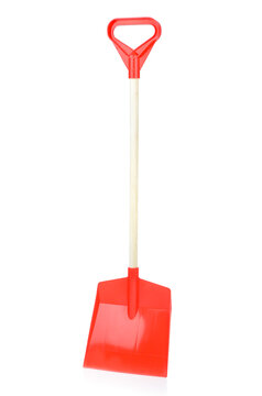 Red plastic shovel isolated on a white background, close-up. Children's toys for playing in the sandbox. Games for early child development. Childhood concept