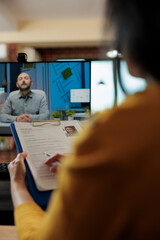 Businesswoman analyzing candidate cv discussing hiring cv with remote man during online videocall...