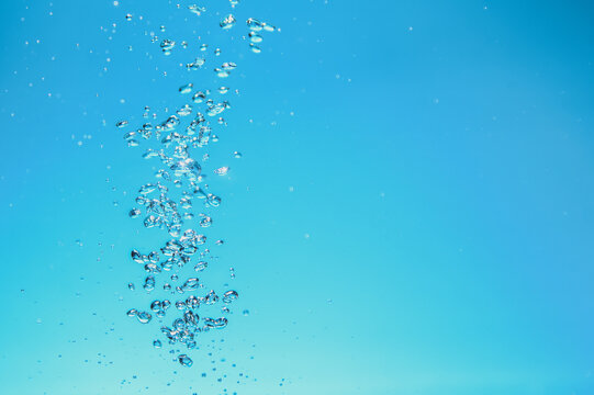 Abstract background image of bubbles in blue water.
