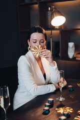 Pretty woman with drink and cards playing poker