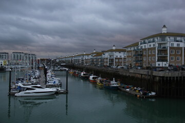 Fototapeta premium Brighton Marina during a cloudy sunset. Moored ships on the water. 