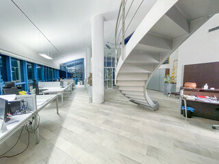 Spiral staircase in a modern and spaciuos office at night. Business concept