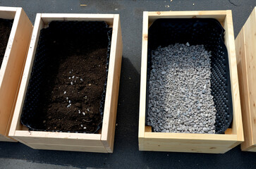 preparation for planting flower pots. wooden flower pots are filled at the bottom with gravel as...