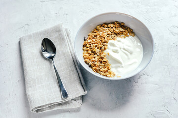 Yogurt with muesli and berries on a gray background.