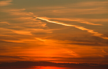 Amazing orange summer sunset with spectacular clouds on sky. Great landscape good to be used as background.