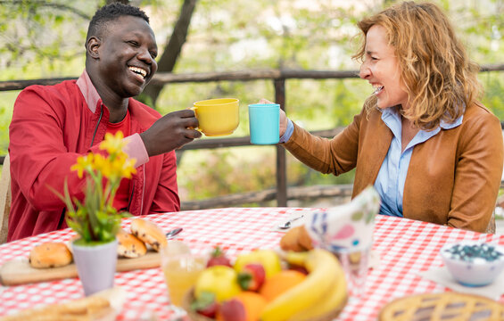 Moments of happy family during brunch in the mountain - Mom and his son  toasting with american coffee