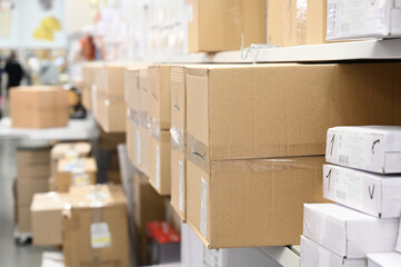 Fototapeta premium Stack of carton boxes at logistics warehouse. Rows of shelves with boxes. Warehouse concept
