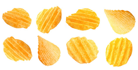 Flying tasty potato chips on white background