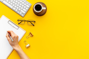 Woman hands working with computer on office table, top view