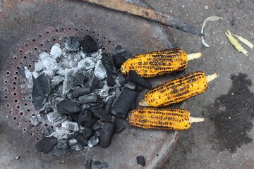 PUNE, INDIA - SEPTEMBER 27, 2015: Top-down image of coal and grilled corn.