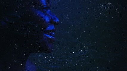 Fototapeta na wymiar Galaxy inspiration. Astrology science. Neon blue side view silhouette of smiling woman face on dark cosmic dust star night sky empty space background.
