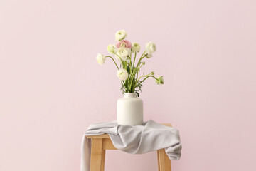 Vase with beautiful bouquet of ranunculus flowers on table