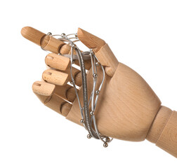 Wooden hand with silver accessory on white background