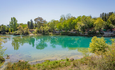 Obraz premium Backwater with emerald water behind the Manavgat waterfall in Side, Turkey