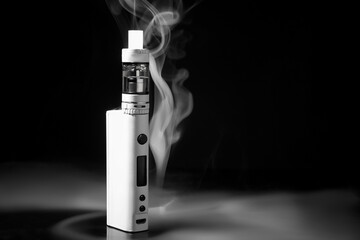 Modern vape mod and smoke on black background