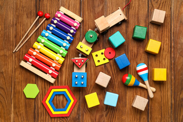 Baby toys with blocks on wooden background