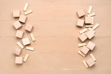 Frame made of cubes and blocks on beige wooden background