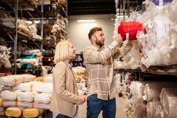 Two business people checking the list and inventory on a tablet. Businesswoman sharing the stock details with warehouse manager.