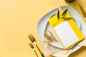 Stylish table setting with blank card and floral decor on color background, closeup