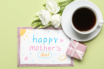 Card with text HAPPY MOTHER'S DAY, gift box, flowers and cup of coffee on green background
