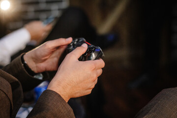 hands of a gamer playing on a gamepad