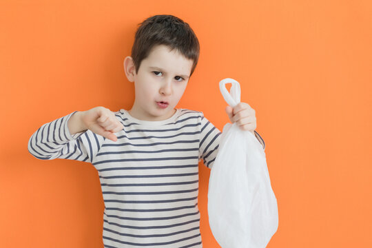Child with plastic bag thumbs down