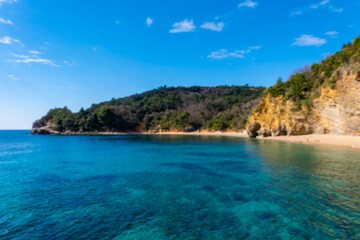 Fototapeta na wymiar Blue water and rocks on the beach near Budva, Montenegro.