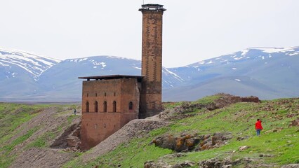 Woman tourist walk around ani archeological site in eastern anatolia, Kars region