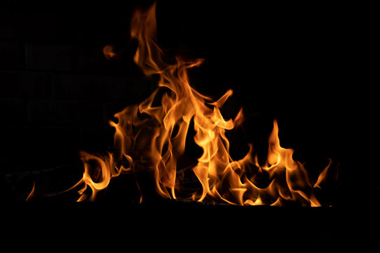 The texture of the fire is close, red and yellow, thermal energy at the fuel supply point at night, lights on a black background.
