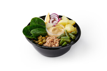 Salad ingredients and mustard sauce in plastic container