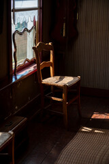 Old fashioned wooden chair in sunlights, Dutch interior and room decoration in rich fisherman's house in North-Holland, Enkhuizen, Netherlands