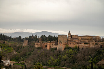 Fototapeta na wymiar View on medieval fortress Alhambra and snow on Sierra Nevada mountains, Granada, Andalusia, Spain