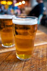 Fresh draught lager beer is glass served in indoor cafe