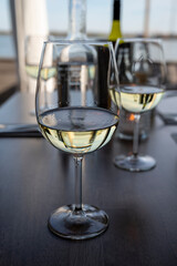 Drinking white dry wine in outdoor cafe with sea view