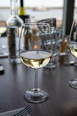 Drinking white dry wine in outdoor cafe with sea view