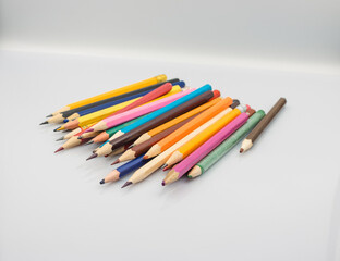 a lot of colored pencils on a white table