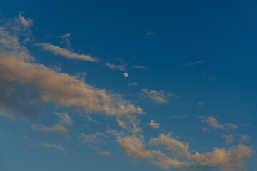 blue sky with clouds and moon