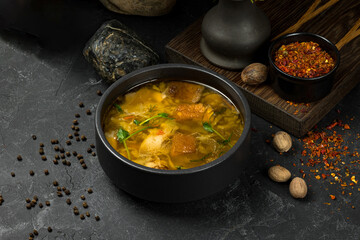 Traditional fresh cabbage soup with mushrooms on stone table