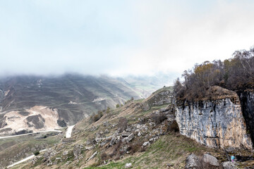 panoramic view of the Caucasus Mountains gorges ancient fortresses and curved mountain roads on a spring day taken from a drone