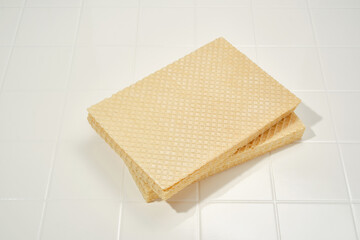 Close up of stack of wafer or waffle sheets on a white background. Shallow depth of field