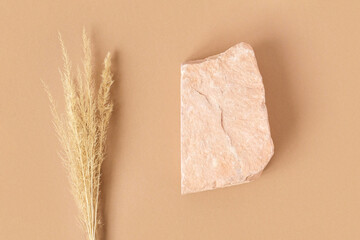 Stone Podium for promotion on beige Background. Natural rock pedestal. Two stones, pampas grass....