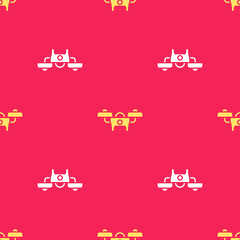 Yellow Drone flying icon isolated seamless pattern on red background. Quadrocopter with video and photo camera symbol. Vector