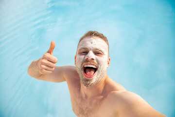 Happy tourist man on background denizli travertine pools blue water in Pamukkale Turkey