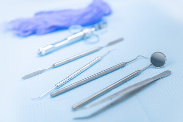 Closeup different dental instruments and tools, blue toning. Concept dentists room office