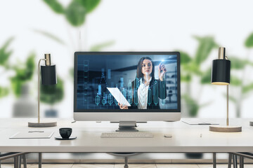  businesswoman giving financial education on screen with business chart, placed on desktop on blurry bright office workplace interior background. 