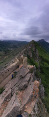 panoramic view of the Caucasus mountains gorges ancient fortresses and curved mountain roads on a spring day