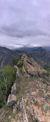 Fototapeta premium panoramic view of the Caucasus mountains gorges ancient fortresses and curved mountain roads on a spring day