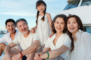 Happy family aboard a yacht out to sea